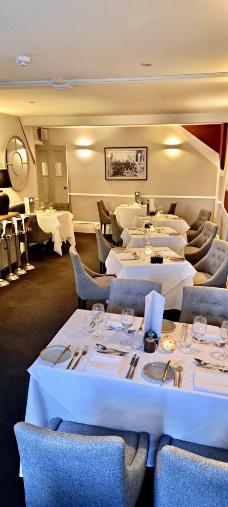 Gently lit dining area at the Aquitania restaurant in the Seaview Hotel